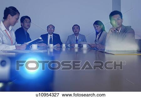 Business Men and Business Women at Meeting, Looking at Screen View Large Photo Image Stock Photo - Business Men and Business Women at Meeting, Looking at Screen. Fotosearch