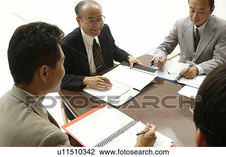 Stock Image - Business Men at Meeting. Fotosearch