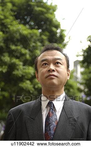 Stock Image - Businessman at street, Tokyo prefecture, Japan. Fotosearch