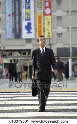 Businessman crossing street, Tokyo prefecture, Japan View Large Photo Image Stock Image - Businessman crossing street, Tokyo prefecture, Japan. Fotosearch