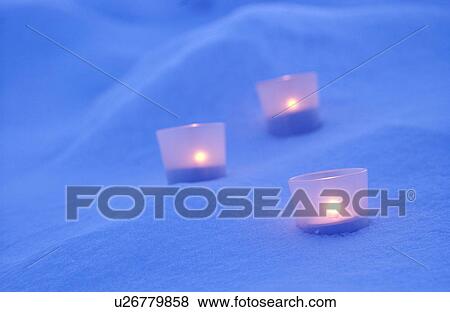 Stock Photo - Candles on snow. Fotosearch