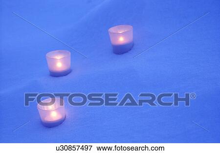 Stock Photo - Candles on snow. Fotosearch