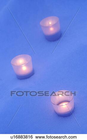 Stock Photograph - Candles on snow. Fotosearch