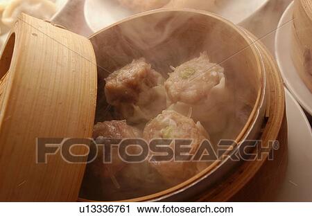 Stock Image - Chinese dumplings in steamer. Fotosearch