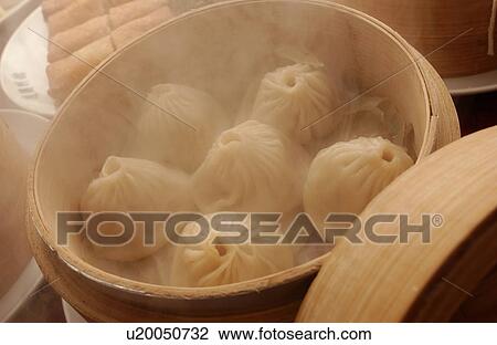 Stock Image - Chinese dumplings in steamer. Fotosearch