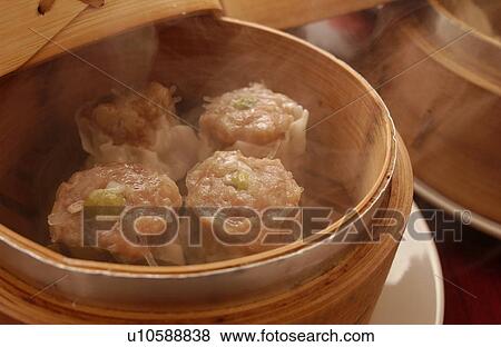 Stock Photo - Chinese dumplings in steamer. Fotosearch