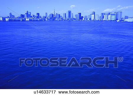 Stock Photo - Cityscape beyond Tokyo bay, toned image, copy space, Tokyo prefecture, Japan. Fotosearch
