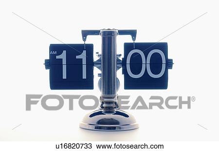 Stock Image - Clock showing 11 o'clock, white background. Fotosearch