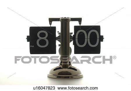 Stock Image - Clock showing 8 o'clock, white background. Fotosearch