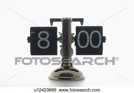 Stock Photo - Clock showing 8 o'clock, white background. Fotosearch