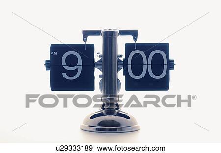 Stock Photo - Clock showing 9 o'clock, white background. Fotosearch