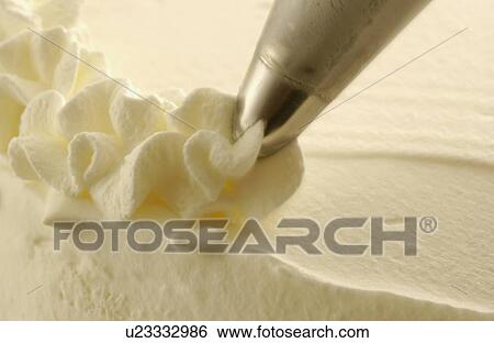 Stock Photograph - Close up of cream decorations. Fotosearch
