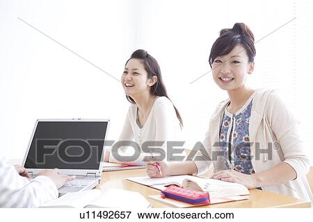 Stock Photo - College students studying using laptop. Fotosearch