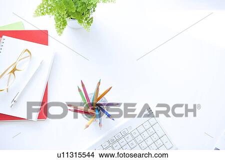 Picture - Colored pencils on desk in office, white background. Fotosearch