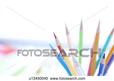Stock Image - Colored pencils on desk in office, close up, differential focus. Fotosearch