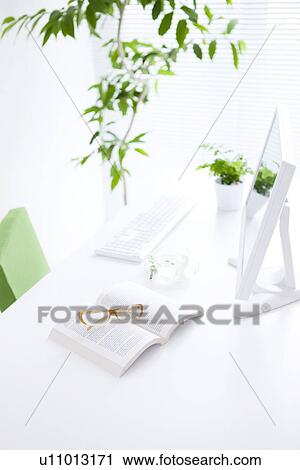 Computer and book on desk in office View Large Photo Image Stock Image - Computer and book on desk in office. Fotosearch