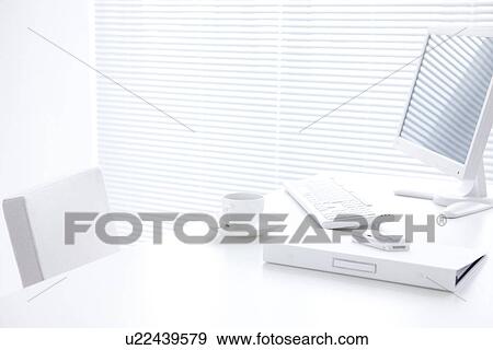 Stock Photo - Computer and coffee cup on desk. Fotosearch