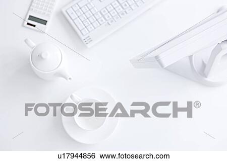 Computer and coffee setting on desk in office, white background View Large Photo Image Stock Photograph - Computer and coffee setting on desk in office, white background. Fotosearch