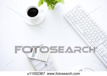 Stock Photo - Computer and cup of coffee on desk in office, white background. Fotosearch
