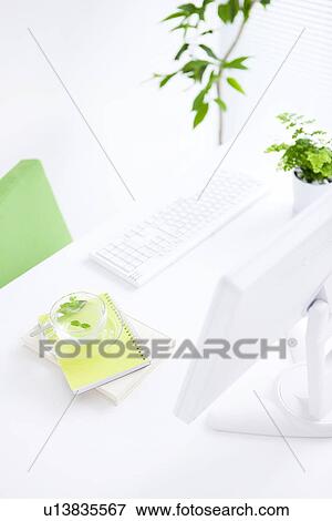 Stock Photo - Computer and cup of herb tea on desk in office. Fotosearch