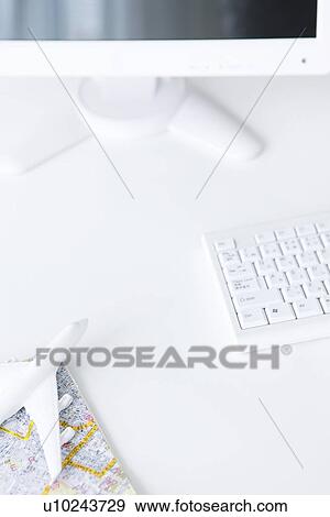 Computer and toy airplane on map, white background View Large Photo Image Stock Photo - Computer and toy airplane on map, white background. Fotosearch