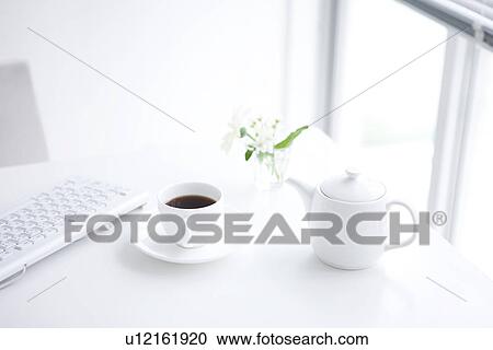 Computer keyboard and cup of coffee on desk in office View Large Photo Image Stock Image - Computer keyboard and cup of coffee on desk in office. Fotosearch