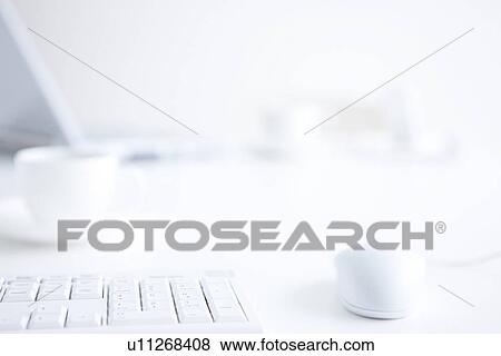 Stock Photo - Computer keyboard and mouse on desk in office, close up, differential focus. Fotosearch
