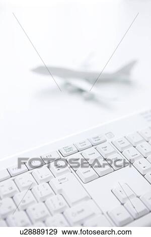 Computer keyboard and toy airplane on white background View Large Photo Image Stock Photo - Computer keyboard and toy airplane on white background. Fotosearch