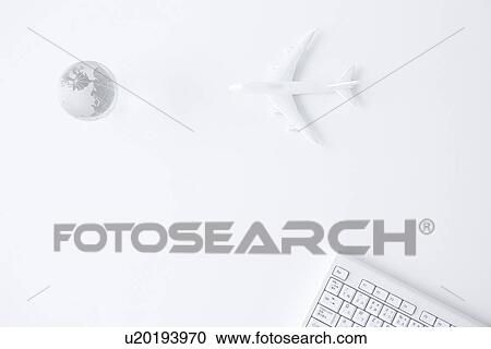 Stock Image - Computer keyboard, globe and toy airplane on white background. Fotosearch