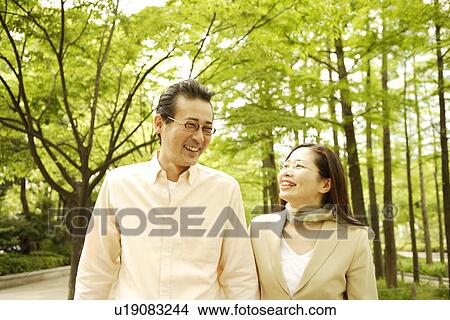 Picture - Couple taking a walk at a park. Fotosearch