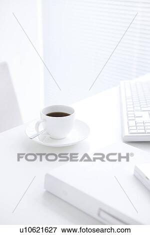 Stock Photo - Cup of coffee on desk. Fotosearch