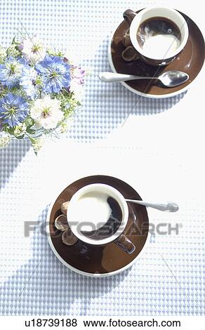 Stock Photo - Cup of Coffees on dining table. Fotosearch