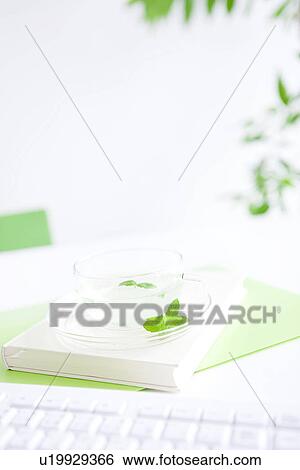 Cup of herb tea on desk in office, differential focus View Large Photo Image Stock Photograph - Cup of herb tea on desk in office, differential focus. Fotosearch