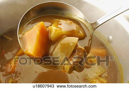 Stock Image - Curry in pan, close up. Fotosearch