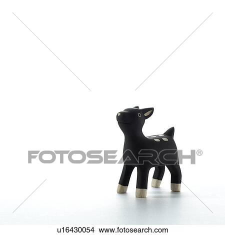 Picture - Deer figurine on white background, copy space. Fotosearch
