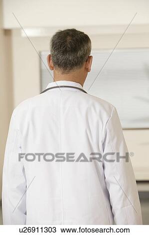 Stock Image - Doctor walking at corridor in hospital. Fotosearch