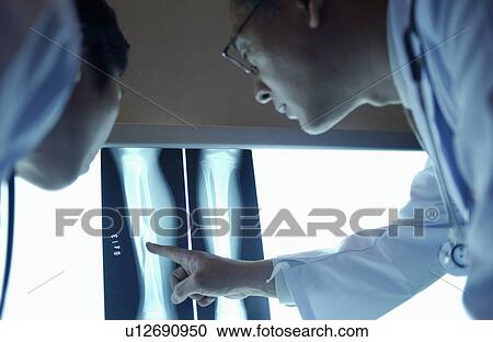 Doctors discussing X-rays View Large Photo Image Stock Image - Doctors discussing X-rays. Fotosearch