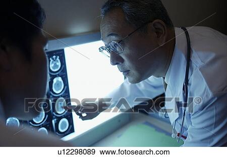 Stock Photo - Doctors discussing X-rays. Fotosearch