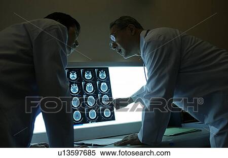 Doctors discussing X-rays View Large Photo Image Stock Photography - Doctors discussing X-rays. Fotosearch