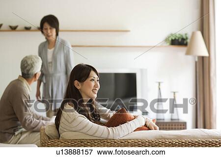 Family in living room, father and daughter sitting on sofa View Large Photo Image Stock Photo - Family in living room, father and daughter sitting on sofa. Fotosearch