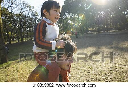 Father carrying son on shoulders, Tokyo Prefecture, Honshu, Japan View Large Photo Image Stock Image - Father carrying son on shoulders, Tokyo Prefecture, Honshu, Japan. Fotosearch