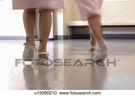 Female nurses walking in corridor quickly, blurred motion View Large Photo Image Stock Image - Female nurses walking in corridor quickly, blurred motion. Fotosearch