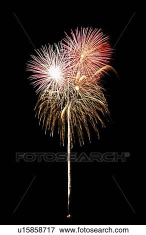 Stock Photo - Fireworks exploding in sky, black background, long exposure. Fotosearch