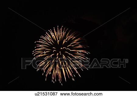 Stock Photo - Fireworks exploding in sky, black background, long exposure. Fotosearch