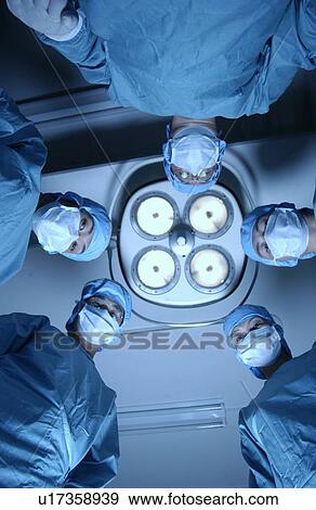 Stock Photo - Five surgeons from operating table. Fotosearch