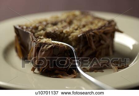 Stock Photo - Fork on sliced chocolate cake, close up. Fotosearch