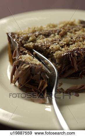 Stock Photo - Fork on sliced chocolate cake, close up. Fotosearch