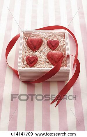 Stock Photo - Four Red Heart Chocolates in Box. Fotosearch