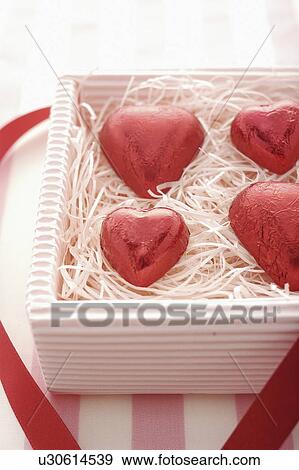 Stock Photo - Four Red Heart Chocolates in Box. Fotosearch