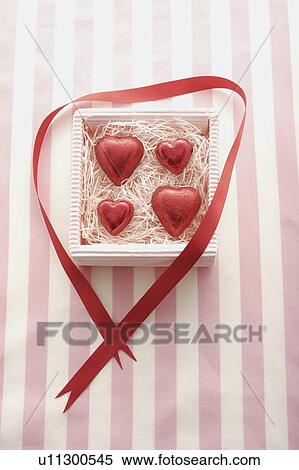 Stock Photography - Four Red Heart Chocolates in Box. Fotosearch